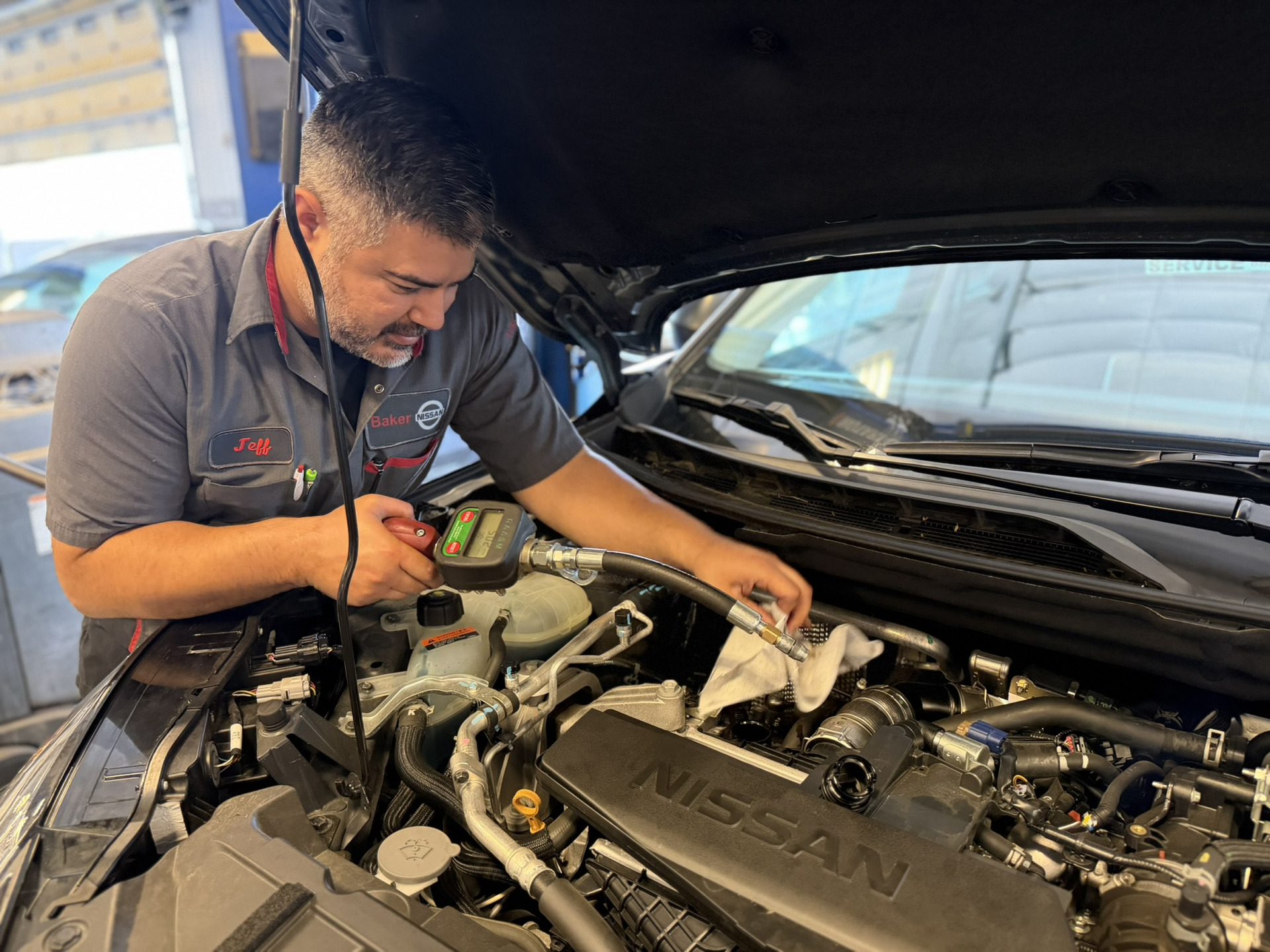 Service tech testing a battery