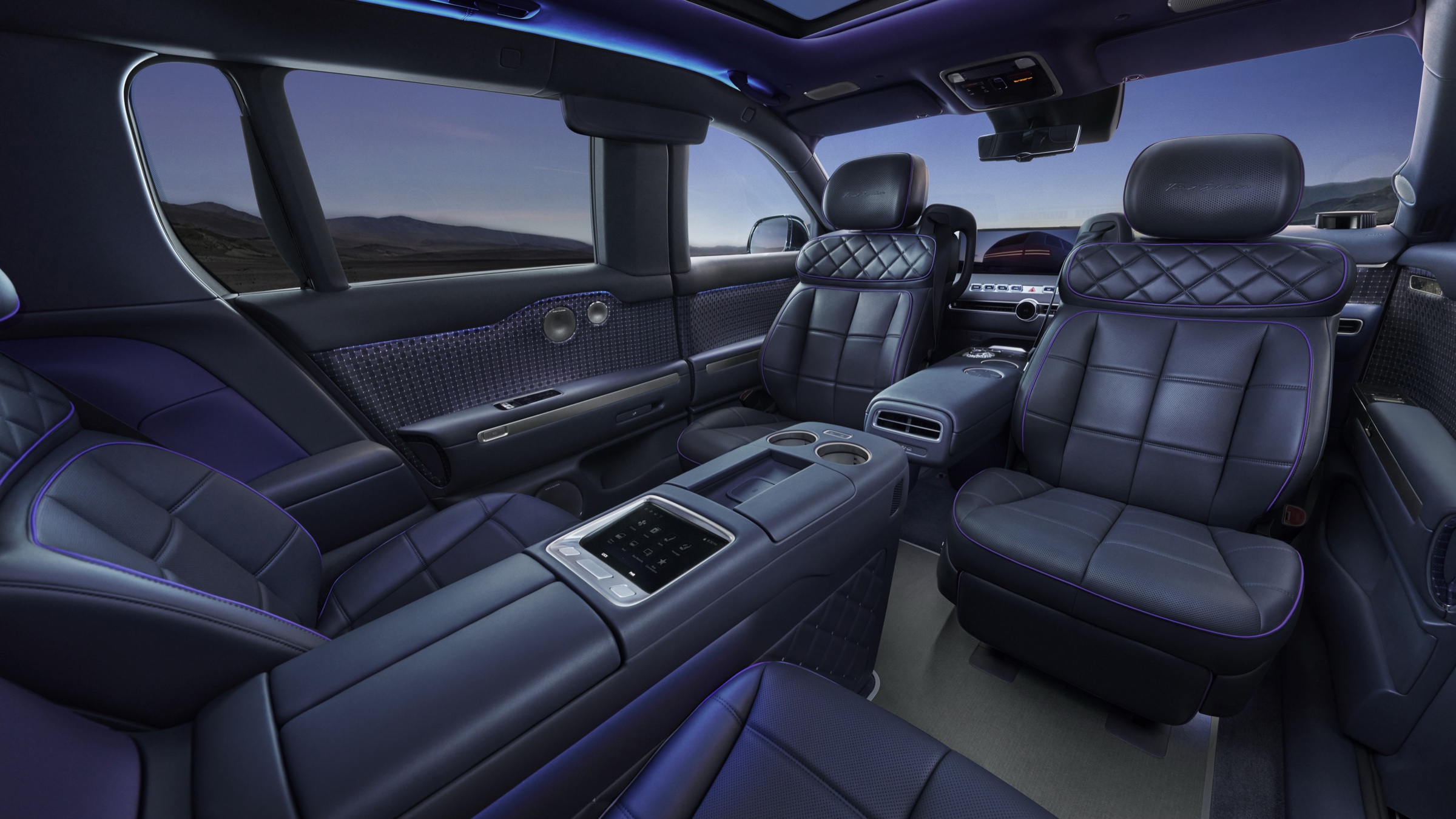 Dark quilted leather GV90 cabin with purple ambient lighting