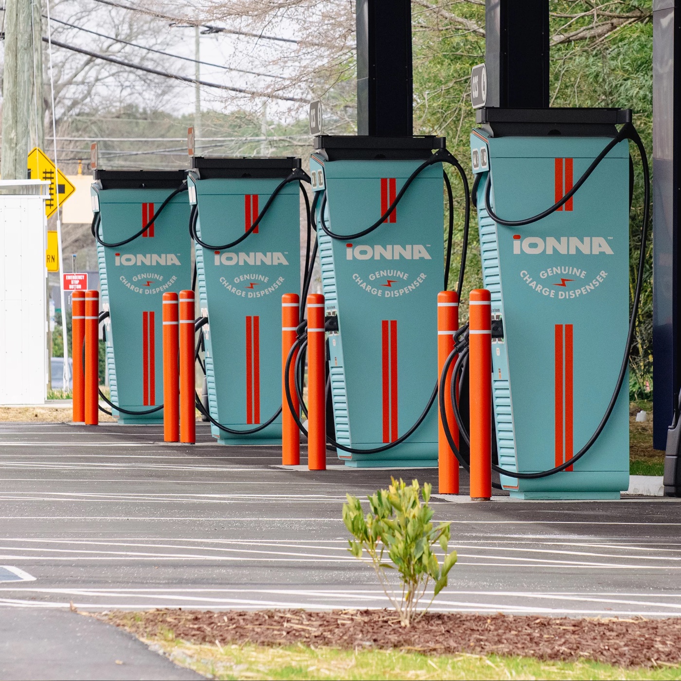 Row of IONNA charging dispensers in a parking lot