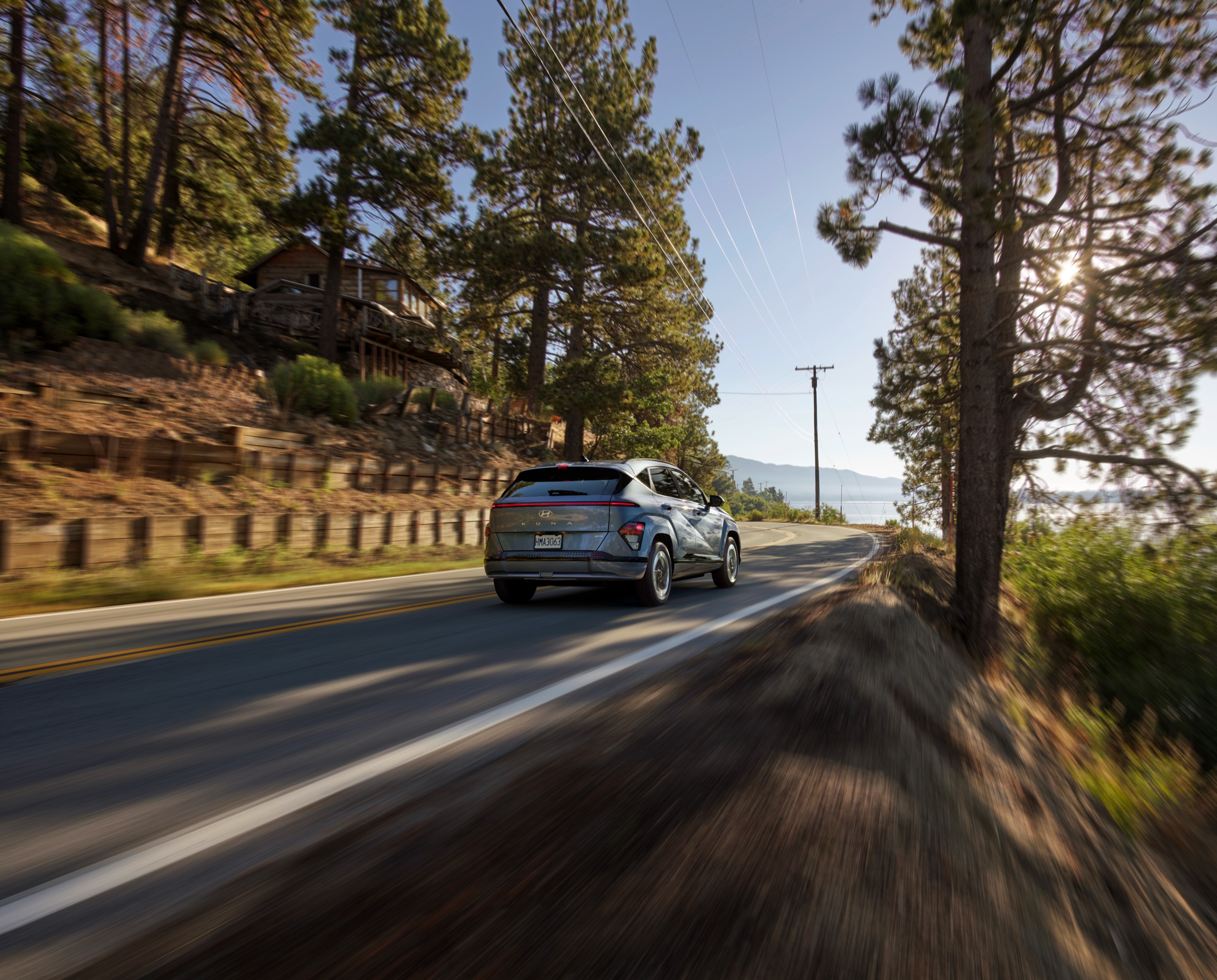 Hyundai KONA Electric driving along a mountain highway