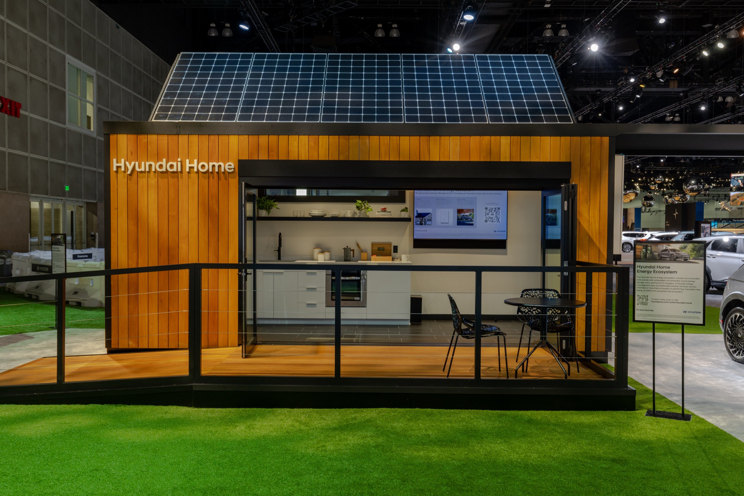 Hyundai Home display with rooftop solar panels and an open living space
