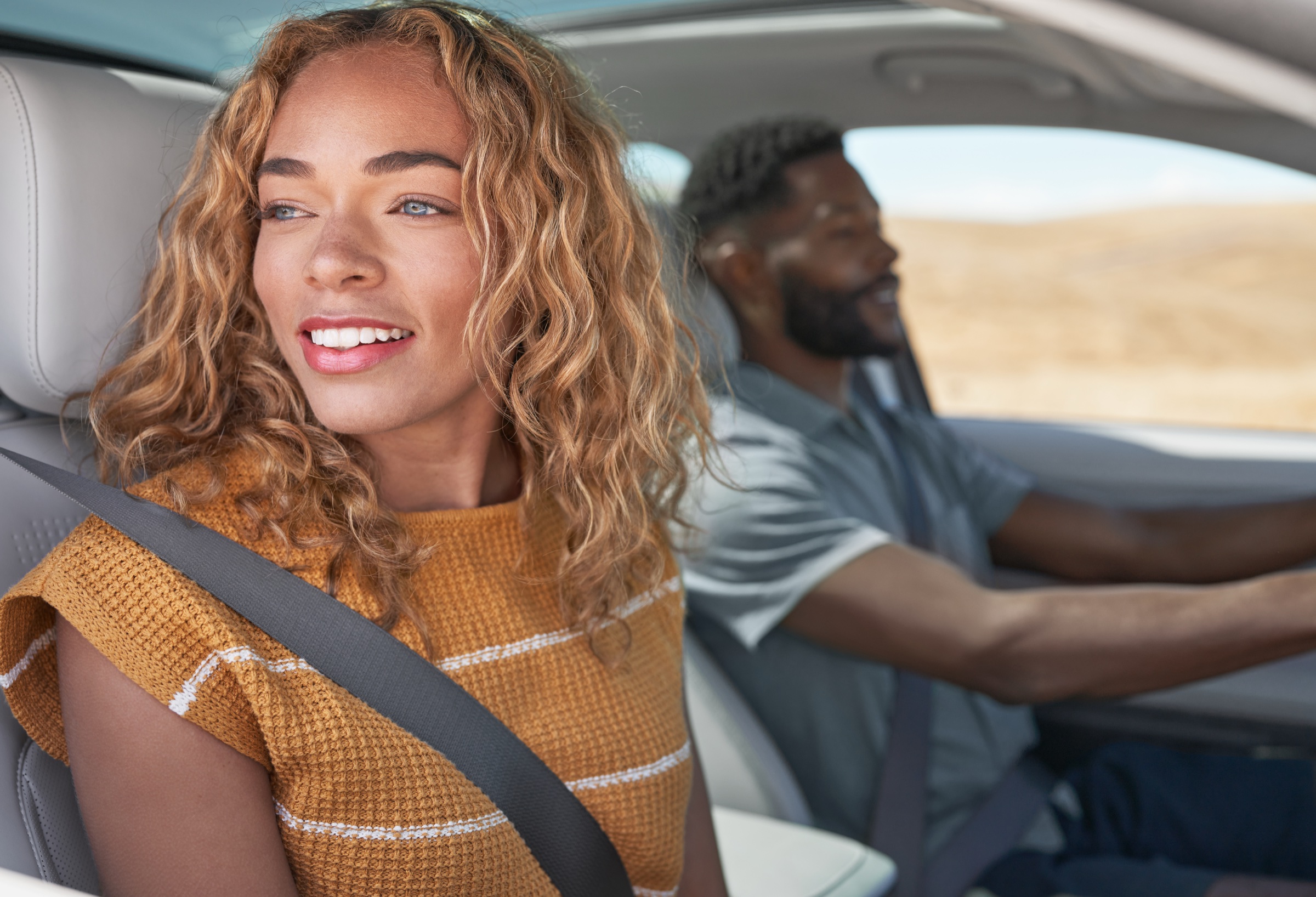 Passenger smiling while looking out from a Hyundai vehicle