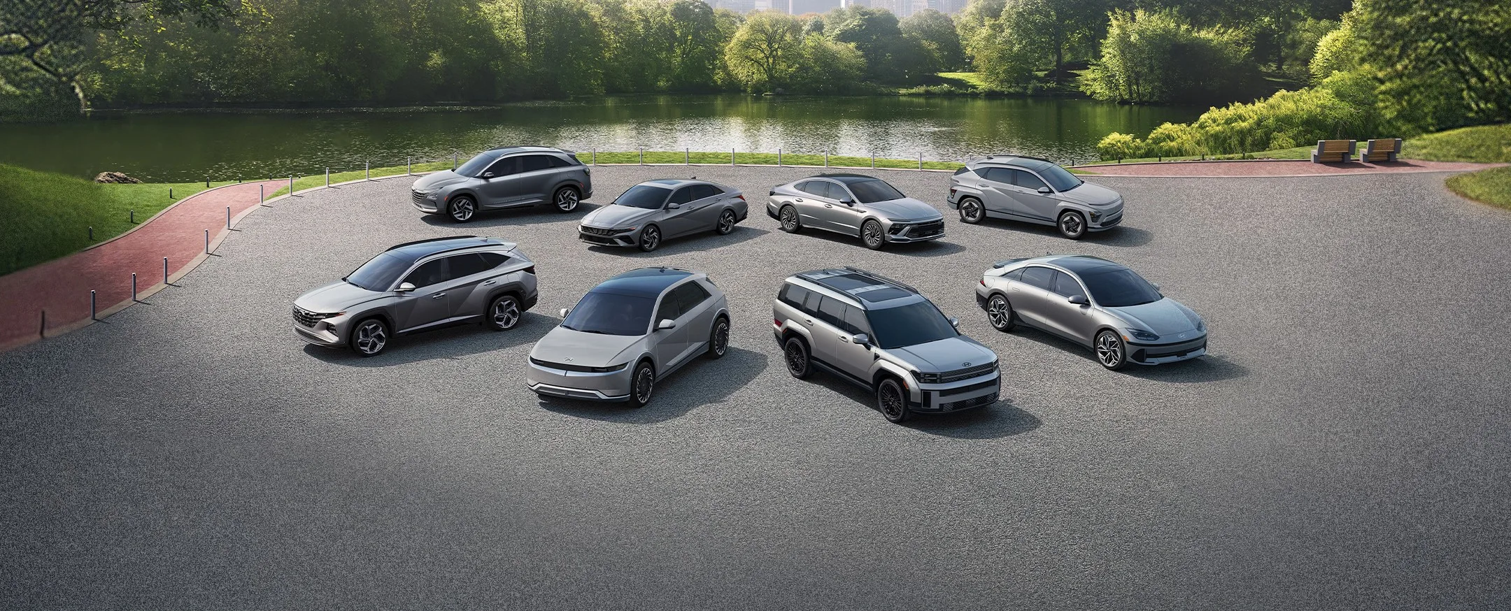 Lineup of Hyundai electrified vehicles parked near a pond