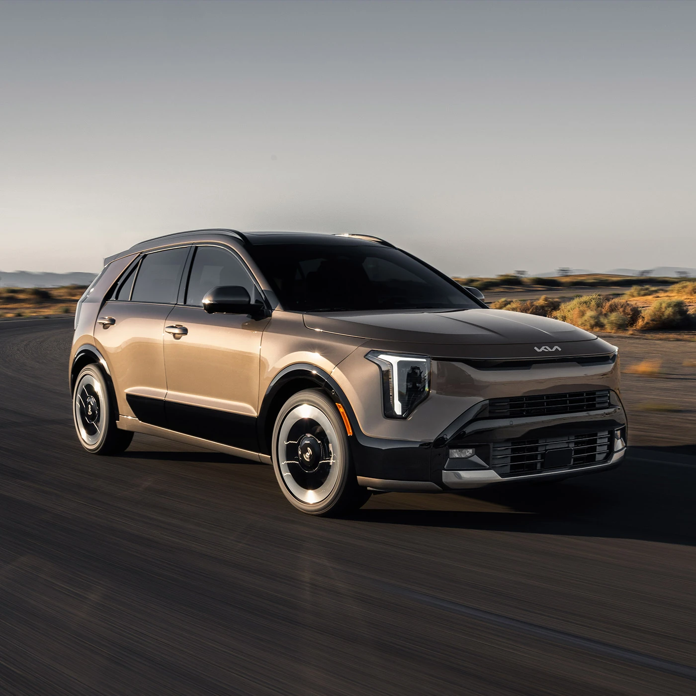 2027 Kia Niro Hybrid SX driving on a coastal road