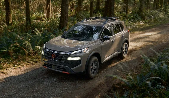 2026.5 Nissan Rogue Rock Creek driving on a forest dirt road.