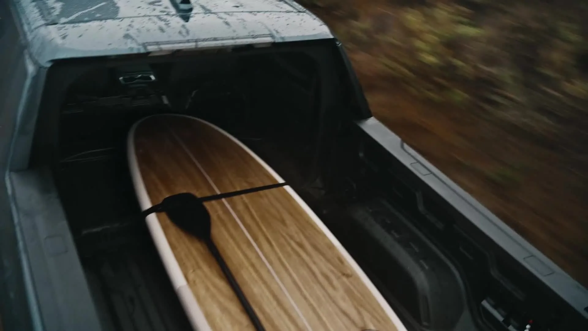 GMC Sierra EV MultiPro Midgate open to extend the cargo bed into the cabin