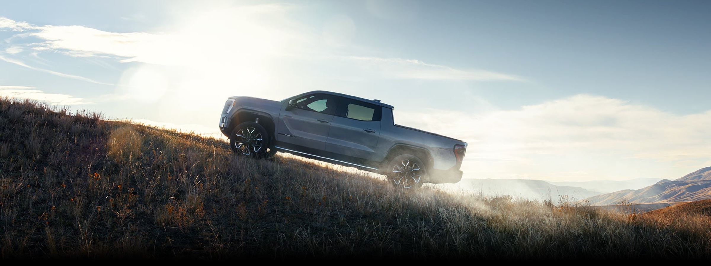 GMC Sierra EV Denali electric pickup showcasing Professional Grade capability on rugged terrain